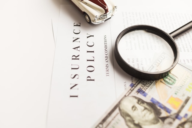 The point of having local moving insurance is protecting your belongings during the relocation. Close-up of an Insurance Policy and a magnifying glass on it